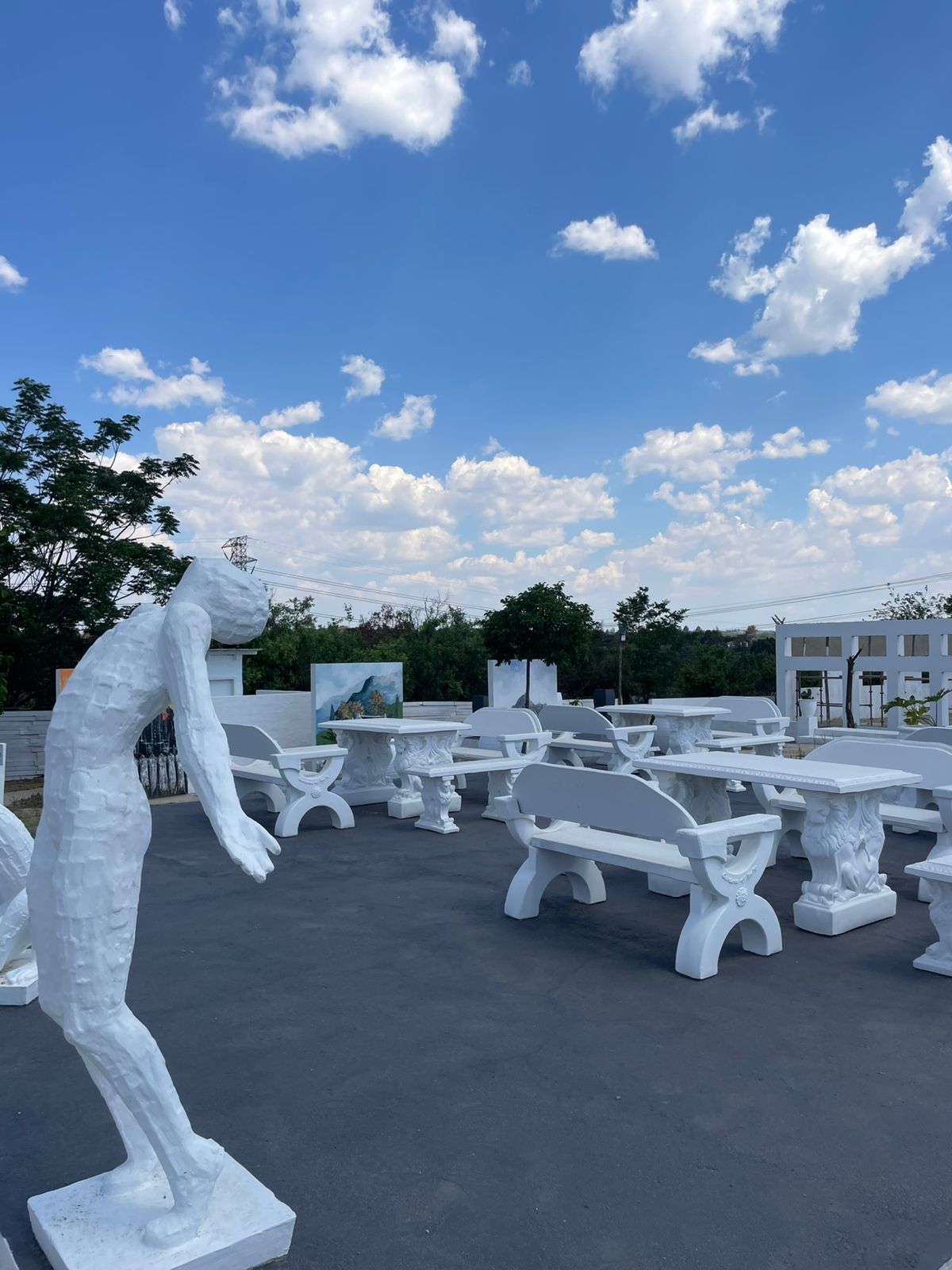 Sculpture garden with white stone benches and outdoor art installations