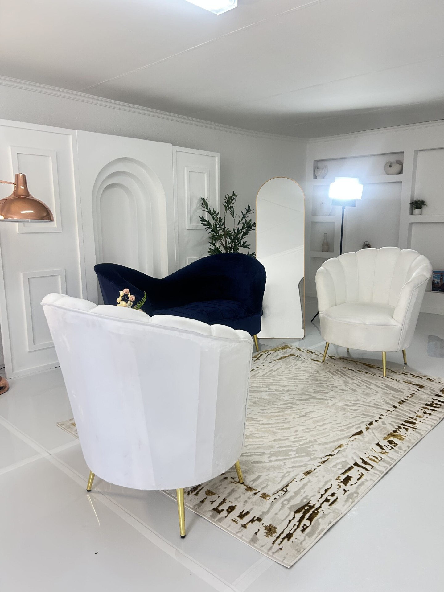 Curated interior lounge with arched panels, mirror and statement lighting